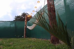 奥克萨潘帕Cabaña Alpina SEAL的挂在围栏旁的树上的吊床
