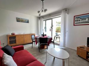 康博莱班Appartement Cambo-les-Bains, 2 pièces, 2 personnes - FR-1-495-62的客厅配有红色的沙发和桌子