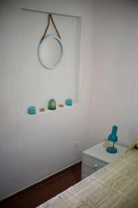 皮里亚波利斯Casa para 4 pers. con entrada de auto y parrillero的卧室配有一张床,墙上设有镜子