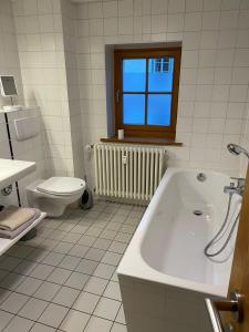 爱尔福特Altstadtwohnung Kromers的白色的浴室设有浴缸和卫生间。