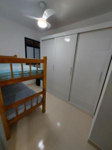 阿拉卡茹Apto na Praia de Atalaia a 100 metros da Passarela do Caranguejo的客房设有衣柜和双层床。