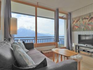 蒙特瓦勒赞Appartement Montvalezan-La Rosière, 3 pièces, 6 personnes - FR-1-398-609的带沙发和大窗户的客厅