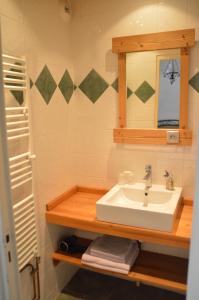 蒂涅勒杰内普酒店的一间带水槽和镜子的浴室