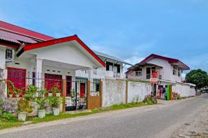 BangkinangSPOT ON 91950 Guest House TekNong Syariah的街道边的一排房子