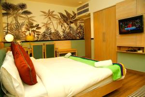新德里AMARA HOTEL的一间卧室设有一张大床,配有电视