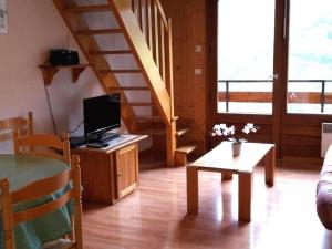 大博尔南Appartement Le Grand-Bornand, 2 pièces, 6 personnes - FR-1-241-21的一间带电视和楼梯的客厅