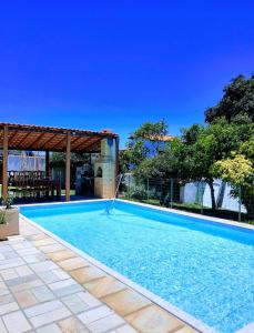 里约热内卢Buganville House Cabo Frio的一座大型游泳池四周设有围栏