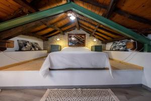 卡利亚里Domus De Gorga - Your Sardinian Apartment的木制天花板客房中间的一张床
