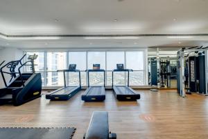 迪拜Luxury Apt - Rooftop Pool - City View的大楼内带跑步机和有氧器材的健身房