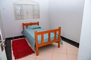 JuínaCasa com Wi-Fi e otima localizacao em Juina MT的一间小卧室,配有一张床和红色地毯