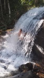 阿蒂巴亚Sitio Anju的一个人躺在瀑布前