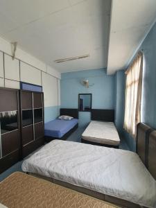 CukaiDeummah Guest Room的蓝色墙壁客房的两张床