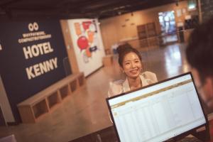 西归浦市Kenny Stay Jeju Seogwipo的站在笔记本电脑前的女人
