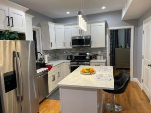 波士顿Brand New Luxury Rooms near downtown Boston的厨房配有冰箱和柜台上的一碗水果