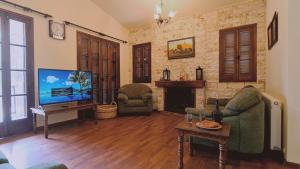 普拉特斯STAY Forest View Villa的客厅配有电视、沙发和壁炉