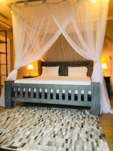 希登盖莱Naara Eco Lodge & Spa的一间卧室配有一张带天蓬的大床