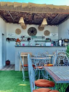 马拉喀什Winarouze house的一个带桌椅的庭院和一间厨房