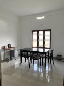 卡尔佩特塔Wayanad Biriyomz Residency, Kalpatta, Low Cost Rooms and Deluxe Apartment的用餐室的桌椅