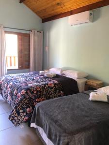 Paiol GrandeChales Sao Felix的一间卧室设有两张床和窗户。