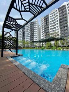 怡保Xii Mountain River View 2R2B 6pax centre of Ipoh的一个大型蓝色游泳池,其建筑背景为: