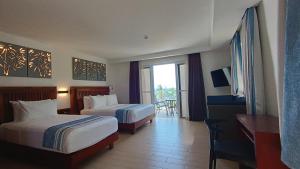 长滩岛Aira Boracay Hotel的酒店客房设有两张床和一个阳台。