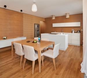希贝尼克希贝尼克D度假酒店的厨房以及带木桌和椅子的用餐室。