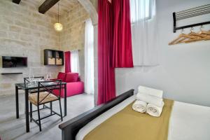 瓦莱塔Vallettastay Old Lodge Studio 5的卧室配有一张床和一张桌子