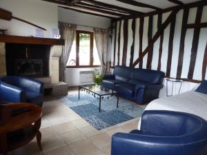 PrigonrieuxGîte du Domaine de Coutancie的客厅配有蓝色的家具和壁炉