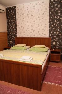 萨尔瓦尔Korona Home的一间卧室配有一张带毛巾的木床