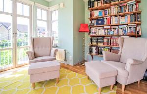 马尔默Awesome Home In Limhamn With House Sea View的客厅配有两把椅子和书架