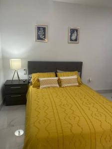 海里亚市Stunning Deluxe Studio的一间卧室配有黄色的床和黄色的毯子