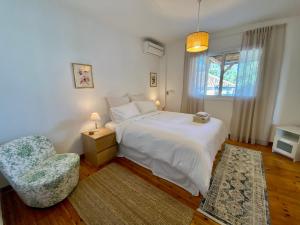 尼科西亚Liberty House - Central Two Bedroom Apartments的卧室配有白色的床和椅子