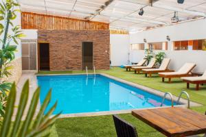 上钦查Hotel Resort Thiago的一个带椅子和桌子的房间的游泳池