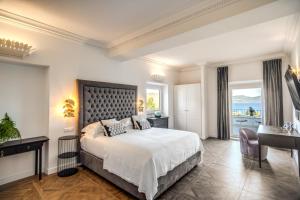 布拉恰诺Vigna Caio Relais & Spa的一间卧室配有一张床、一张书桌和一个窗户。