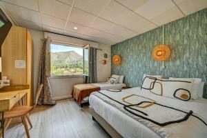 热姆诺普罗旺斯酒店的酒店客房设有两张床和窗户。