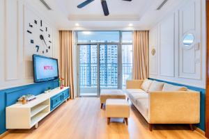 胡志明市Moxy HCMC Aparts - Vinhomes Central Park, Ice Rink的带沙发和电视的客厅