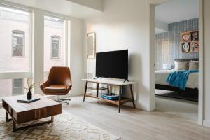 明尼阿波利斯Sonder at SECOND & SECOND的一间卧室配有一张床和一张书桌及电视