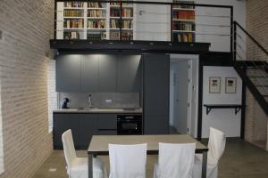 塞维利亚COZY & MODERN APARTMENT HOMBRE DE PIEDRA的厨房以及带桌椅的用餐室。