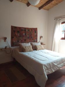 蒂尔卡拉Casona Inkill Huasi II的卧室配有一张大白色床和窗户
