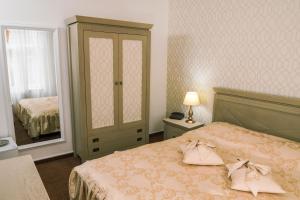 比斯特里察HOTEL CORA Bistrita的一间卧室配有一张带梳妆台和镜子的床