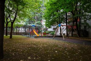米兰Rucellai Guest House的公园设有带滑梯和树木的游乐场