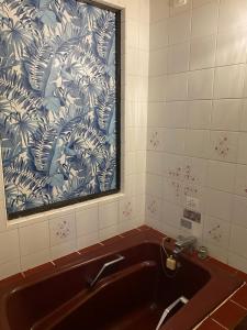 东京Hotel OLDSWING Adult Only的浴室设有水槽,配有蓝色和白色的壁纸
