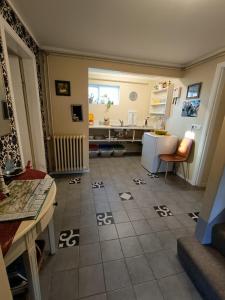 维克Arsalir Guesthouse Vik B&B的厨房铺有瓷砖地板,配有桌子和冰箱。