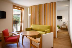仕格莱伊卡伦美食酒店的客厅配有绿色沙发和桌子