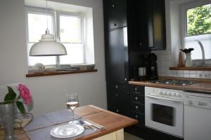 基姆湖畔普林Ferienwohnung am Herrnberg的厨房配有一张桌子和一杯葡萄酒