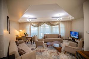 尼亚美Niamey Mall & Residence的带沙发、电视和桌子的客厅