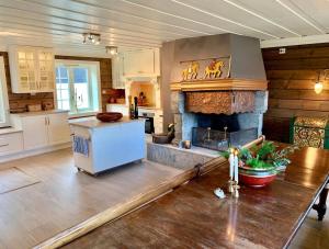 Traditional timber farm with Sauna & Wi-Fi的厨房设有带壁炉的客厅。