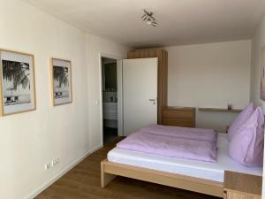 博霍尔特Ostwall Terrassen Apartment 5.33的一间卧室配有一张带紫色枕头的床