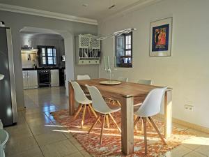 伊斯纳哈尔Casa Las Majadillas的一间带木桌和白色椅子的用餐室