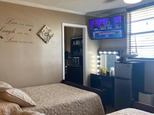 代托纳海滩Ocean View Renovated Condo With Pool - DAYTONA BEACH的卧室配有一张床,墙上配有电视。